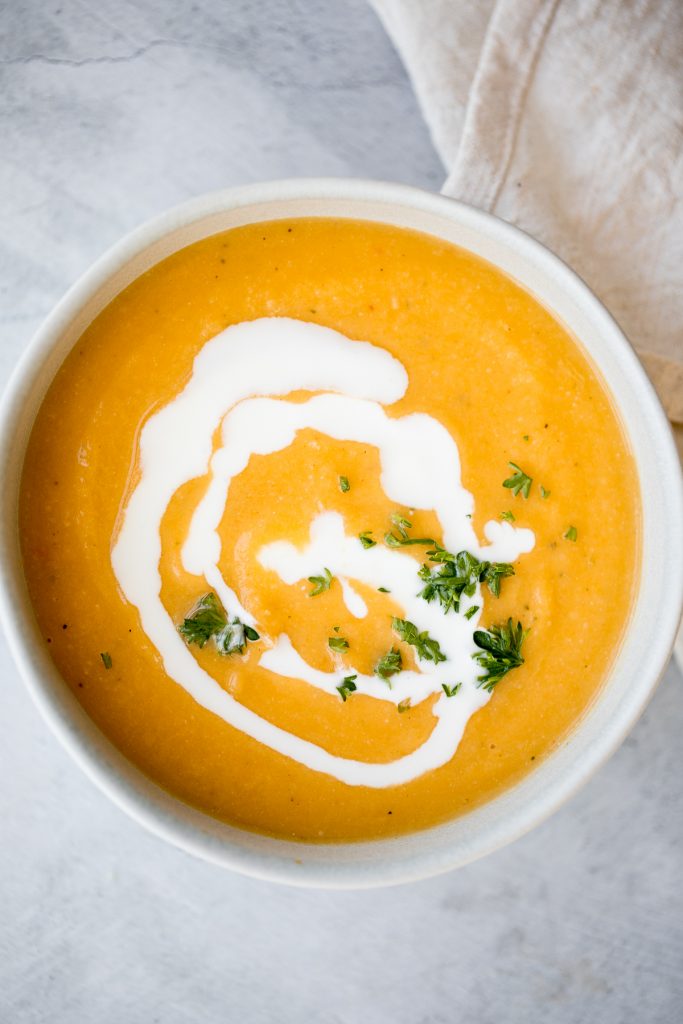 Creamy roasted butternut squash and cauliflower soup has all the fall feels and is vegan and gluten-free. Plus, it's super easy to make in a sheet pan. | aheadofthyme.com