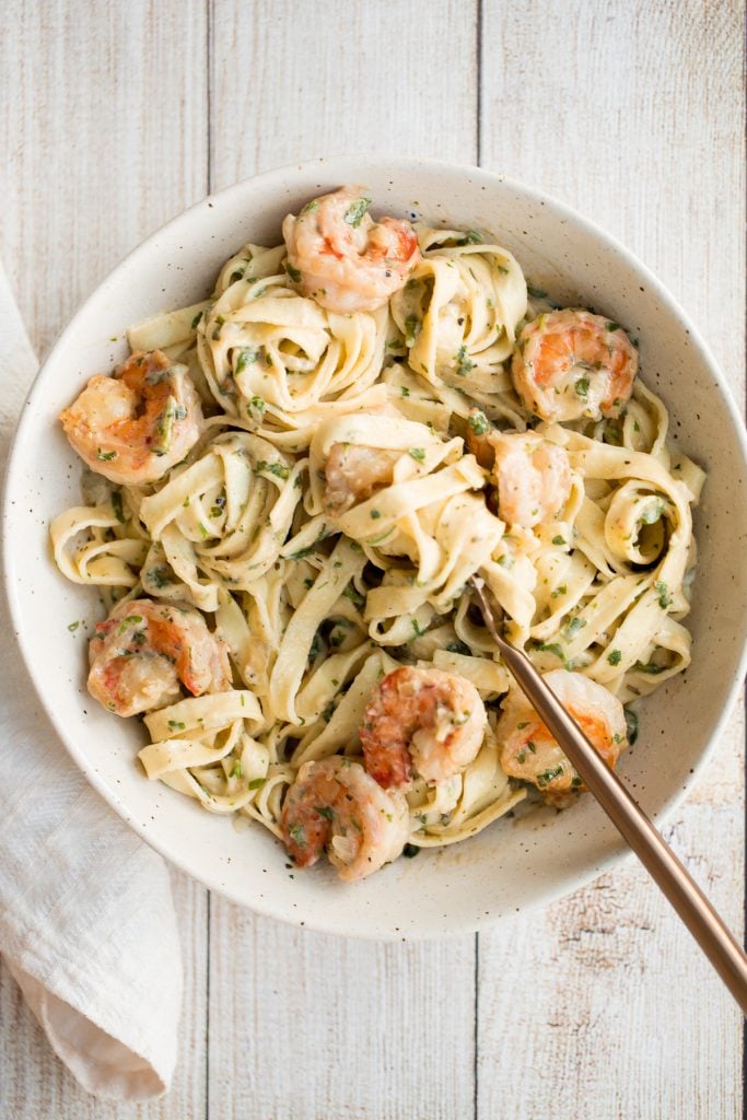 Creamy shrimp fettuccine alfredo pasta bake is garlicky, buttery, cheesy, loaded with shrimp + parsley and topped with mozzarella. Easy comfort food goals. | aheadofthyme.com