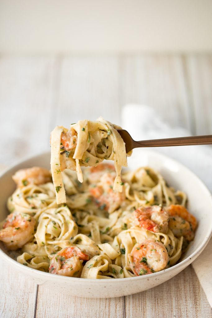 Creamy shrimp fettuccine alfredo pasta bake is garlicky, buttery, cheesy, loaded with shrimp + parsley and topped with mozzarella. Easy comfort food goals. | aheadofthyme.com