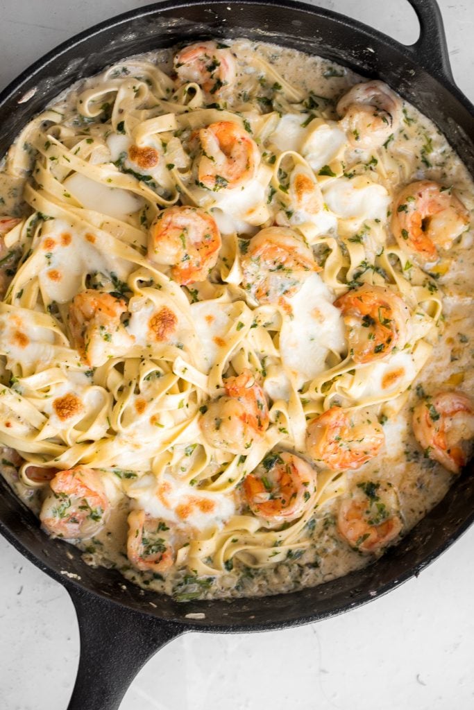 Creamy shrimp fettuccine alfredo pasta bake is garlicky, buttery, cheesy, loaded with shrimp + parsley and topped with mozzarella. Easy comfort food goals. | aheadofthyme.com