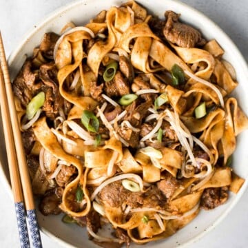 Better than takeout, these stir-fried Spicy Cumin Lamb Noodles are made with marinated lamb, noodles, and crisp bean sprouts. Make it in 15 minutes! | aheadofthyme.com