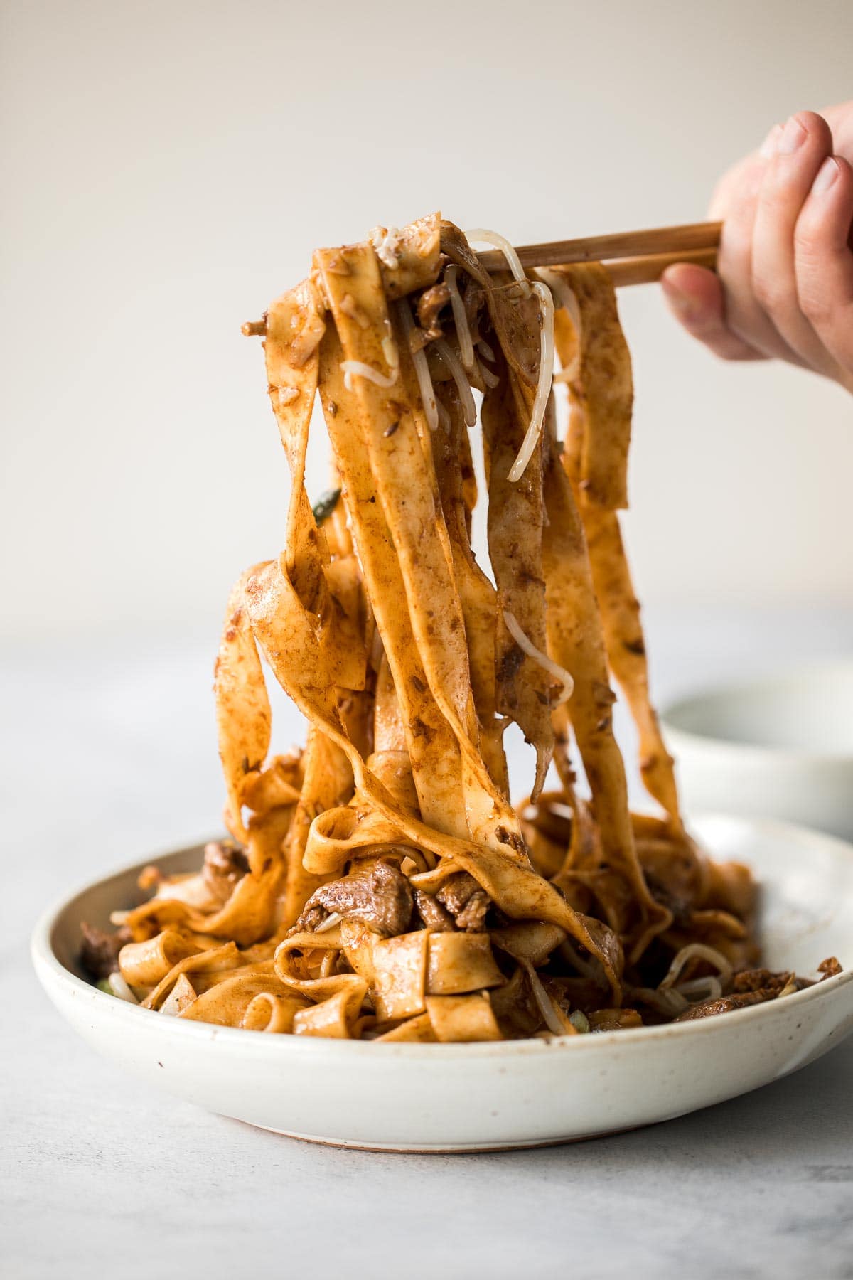 Better than takeout, these stir-fried Spicy Cumin Lamb Noodles are made with marinated lamb, noodles, and crisp bean sprouts. Make it in 15 minutes! | aheadofthyme.com