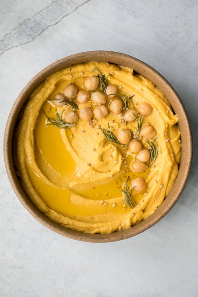 Make creamy pumpkin hummus in under 5 minutes with a few pantry staples including canned pumpkin. It's the best healthy and delicious fall snack or appy. | aheadofthyme.com