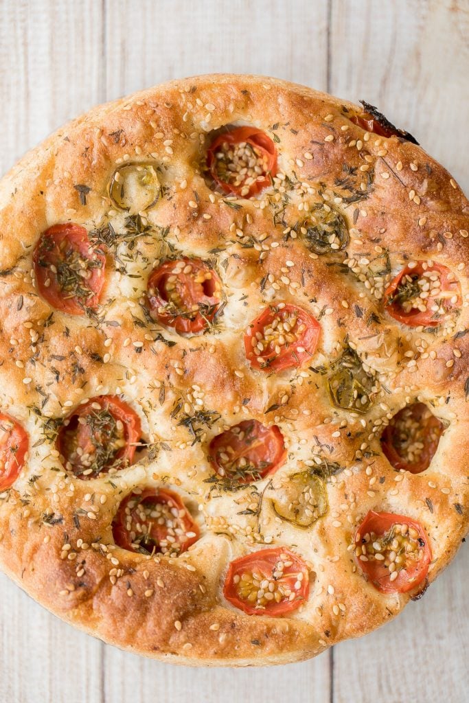 Easy no knead tomato focaccia is so flavourful, packed with olive oil, tomatoes and fresh herbs. It's crispy and golden outside, fluffy and pillowy inside. | aheadofthyme.com