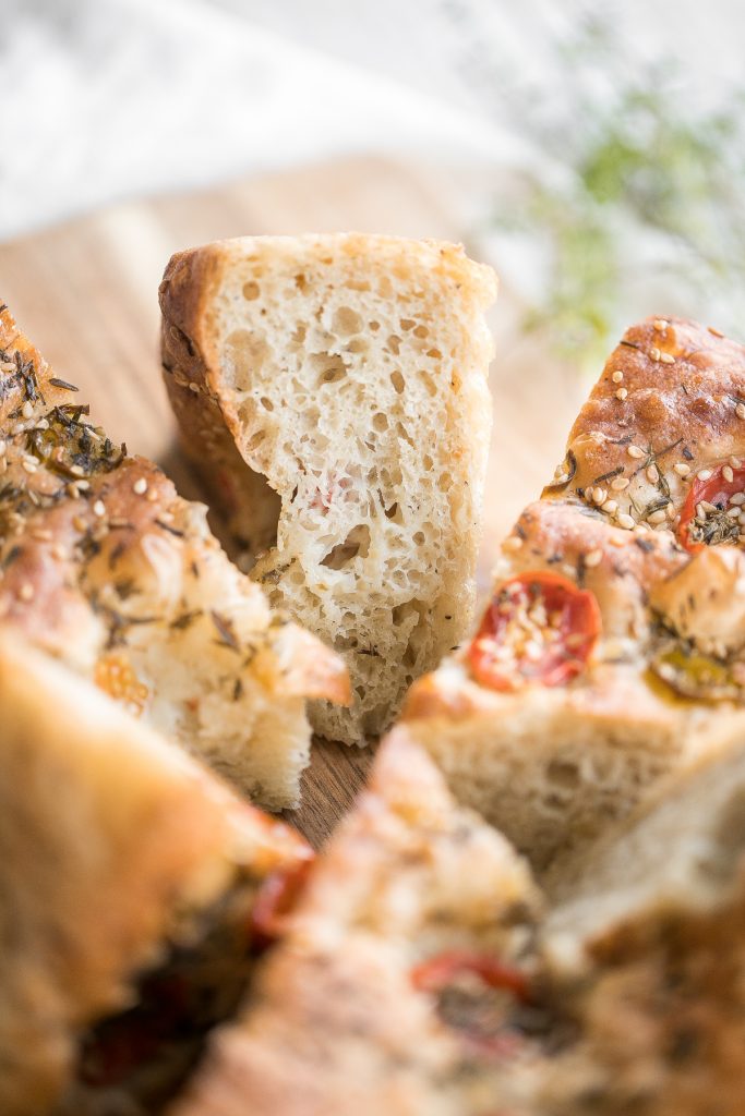Easy no knead tomato focaccia is so flavourful, packed with olive oil, tomatoes and fresh herbs. It's crispy and golden outside, fluffy and pillowy inside. | aheadofthyme.com