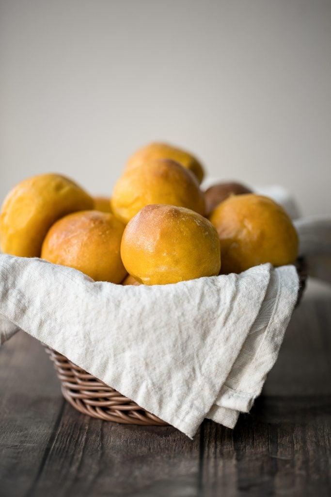 Quick and easy pumpkin dinner rolls are soft and fluffy, flaky and butter, and perfect to serve alongside a warm and cozy fall meal or Thanksgiving dinner. | aheadofthyme.com