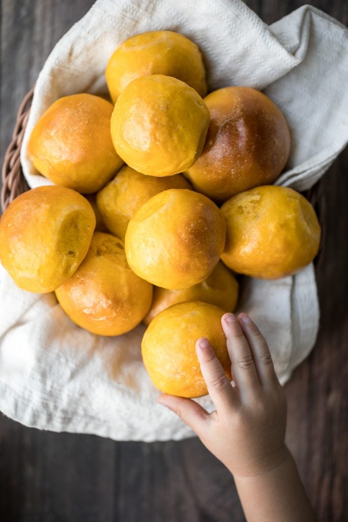 Quick and easy pumpkin dinner rolls are soft and fluffy, flaky and butter, and perfect to serve alongside a warm and cozy fall meal or Thanksgiving dinner. | aheadofthyme.com