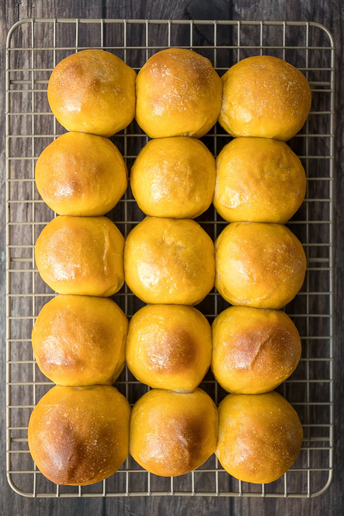 Quick and easy pumpkin dinner rolls are soft and fluffy, flaky and butter, and perfect to serve alongside a warm and cozy fall meal or Thanksgiving dinner. | aheadofthyme.com