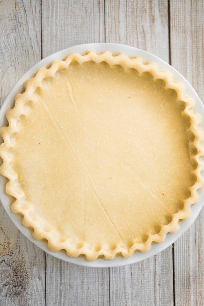 Unbaked pie crust with crimped, fluted edges in a pie dish
