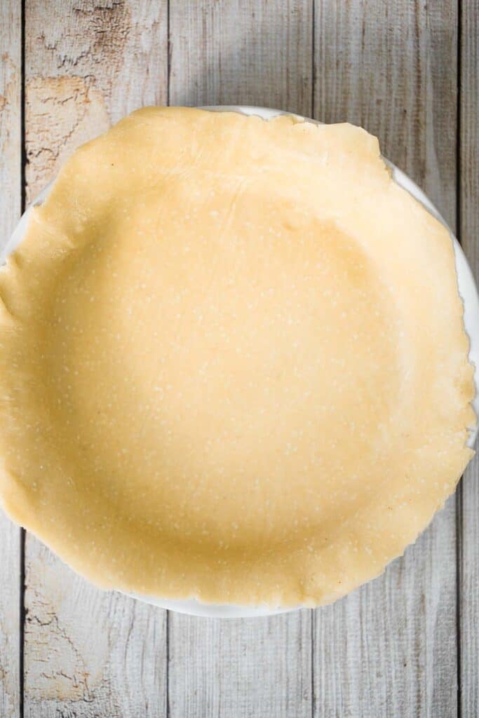Unbaked pie crust pressed into a pie dish, ready for filling