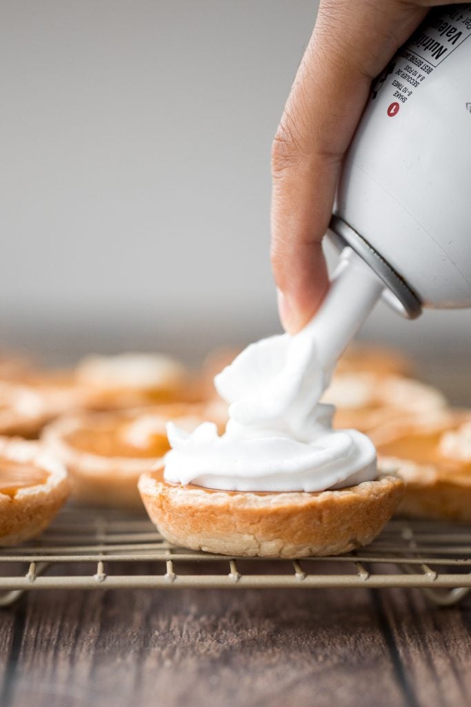 Small batch mini pumpkin pies with a flaky crust, delicious pumpkin pie filling, and cinnamon whipped cream, are perfect for a small Thanksgiving crowd. | aheadofthyme.com