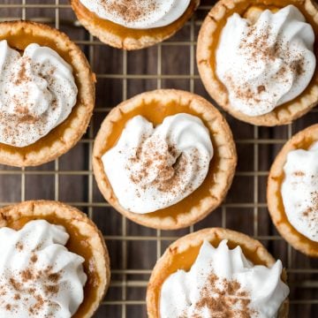 Small batch mini pumpkin pies with a flaky crust, delicious pumpkin pie filling, and cinnamon whipped cream, are perfect for a small Thanksgiving crowd. | aheadofthyme.com