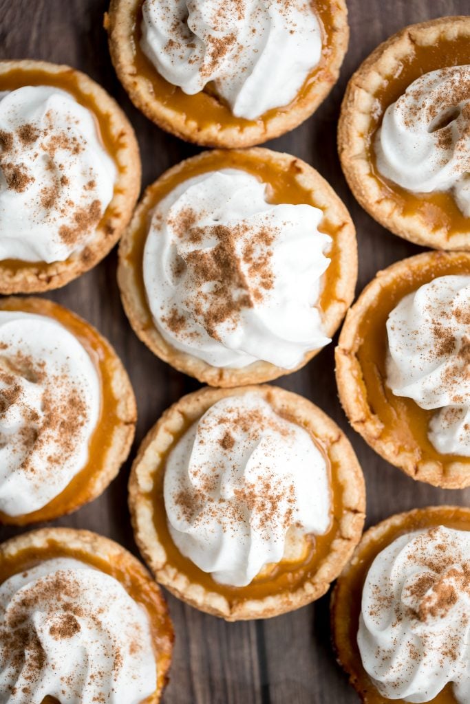 Small batch mini pumpkin pies with a flaky crust, delicious pumpkin pie filling, and cinnamon whipped cream, are perfect for a small Thanksgiving crowd. | aheadofthyme.com