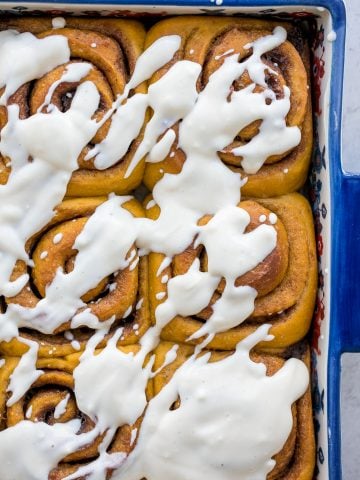 Soft and fluffy, pumpkin cinnamon rolls are packed with pumpkin, layered with pumpkin spice, and topped with cream cheese icing. Best fall treat ever. | aheadofthyme.com