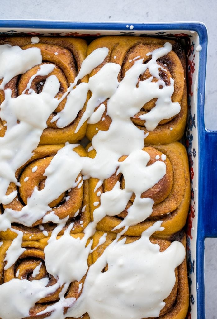 Soft and fluffy, pumpkin cinnamon rolls are packed with pumpkin, layered with pumpkin spice, and topped with cream cheese icing. Best fall treat ever. | aheadofthyme.com