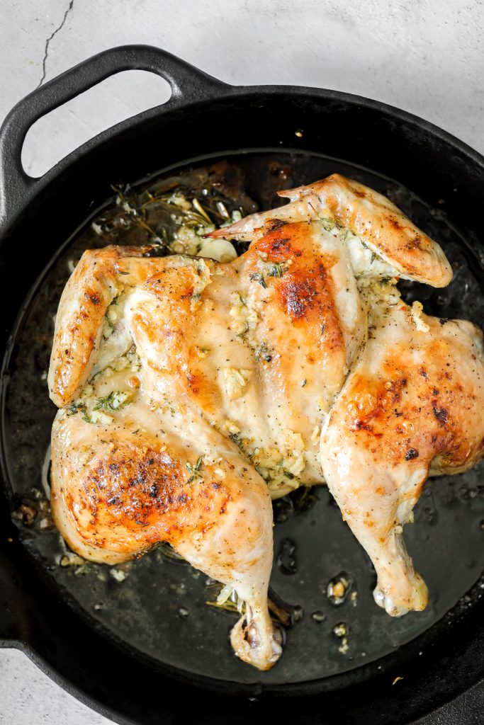 Quick and easy roasted spatchcock chicken (butterflied chicken) seasoned with garlic and thyme is juicy, tender, delicious and flavourful with minimal prep. | aheadofthyme.com