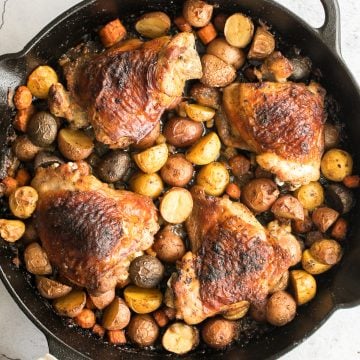 Tender, juicy, and crispy one pan skillet chicken thighs and potatoes and carrots is an easy weeknight dinner on your dinner table in less than 45 minutes. | aheadofthyme.com