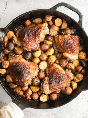 Tender, juicy, and crispy one pan skillet chicken thighs and potatoes and carrots is an easy weeknight dinner on your dinner table in less than 45 minutes. | aheadofthyme.com