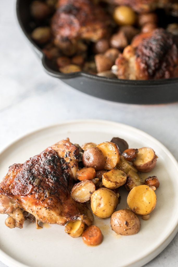 Tender, juicy, and crispy one pan skillet chicken thighs and potatoes and carrots is an easy weeknight dinner on your dinner table in less than 45 minutes. | aheadofthyme.com