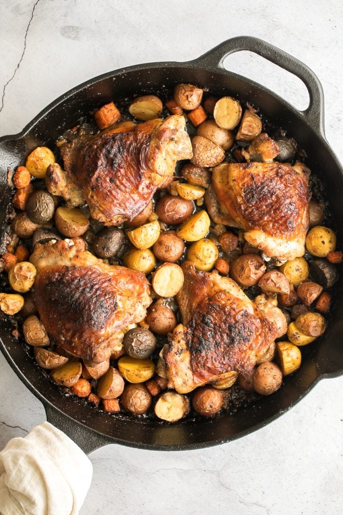 Tender, juicy, and crispy one pan skillet chicken thighs and potatoes and carrots is an easy weeknight dinner on your dinner table in less than 45 minutes. | aheadofthyme.com