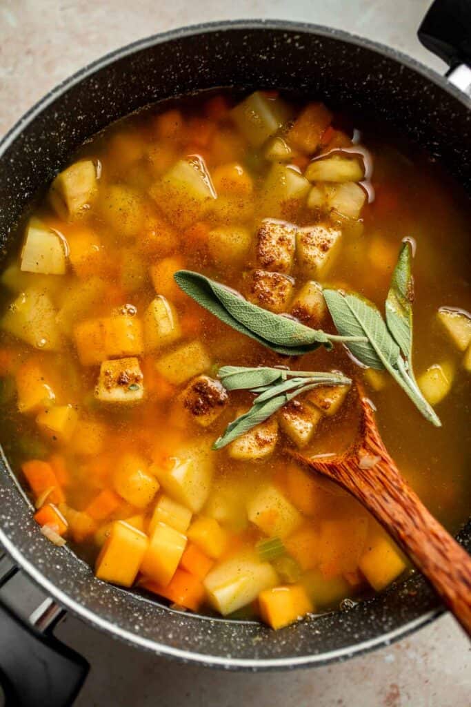 Butternut Squash Apple Soup is healthy and simple yet packed with so much flavour. Top this easy vegan soup with a layer of homemade toasted croutons. | aheadofthyme.com