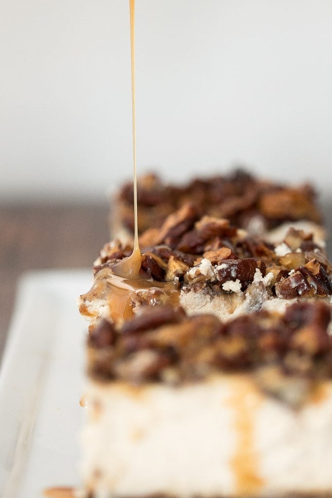 Decadent caramel pecan pie cheesecake bars with a graham cracker crust, cheesecake filling, and caramel pecan topping is perfect for Thanksgiving this fall. | aheadofthyme.com