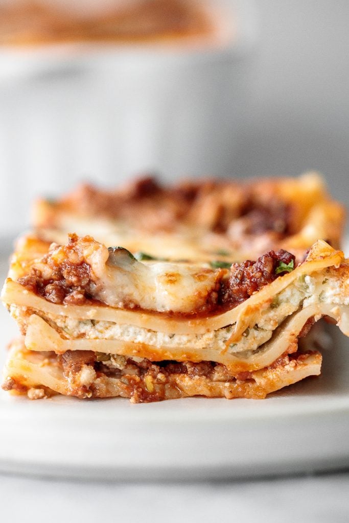 Classic easy meat lasagna is the ultimate Italian comfort food with layers of tender lasagna, meaty tomato sauce, cheese filling and melted cheese on top. | aheadofthyme.com