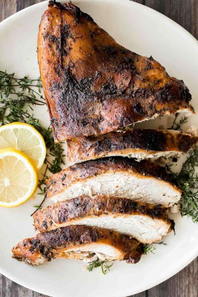 Juicy slow cooker turkey breast with crispy skin, garlic, and fresh herbs. An easy crockpot recipe for tender, flavorful turkey every time. | aheadofthyme.com