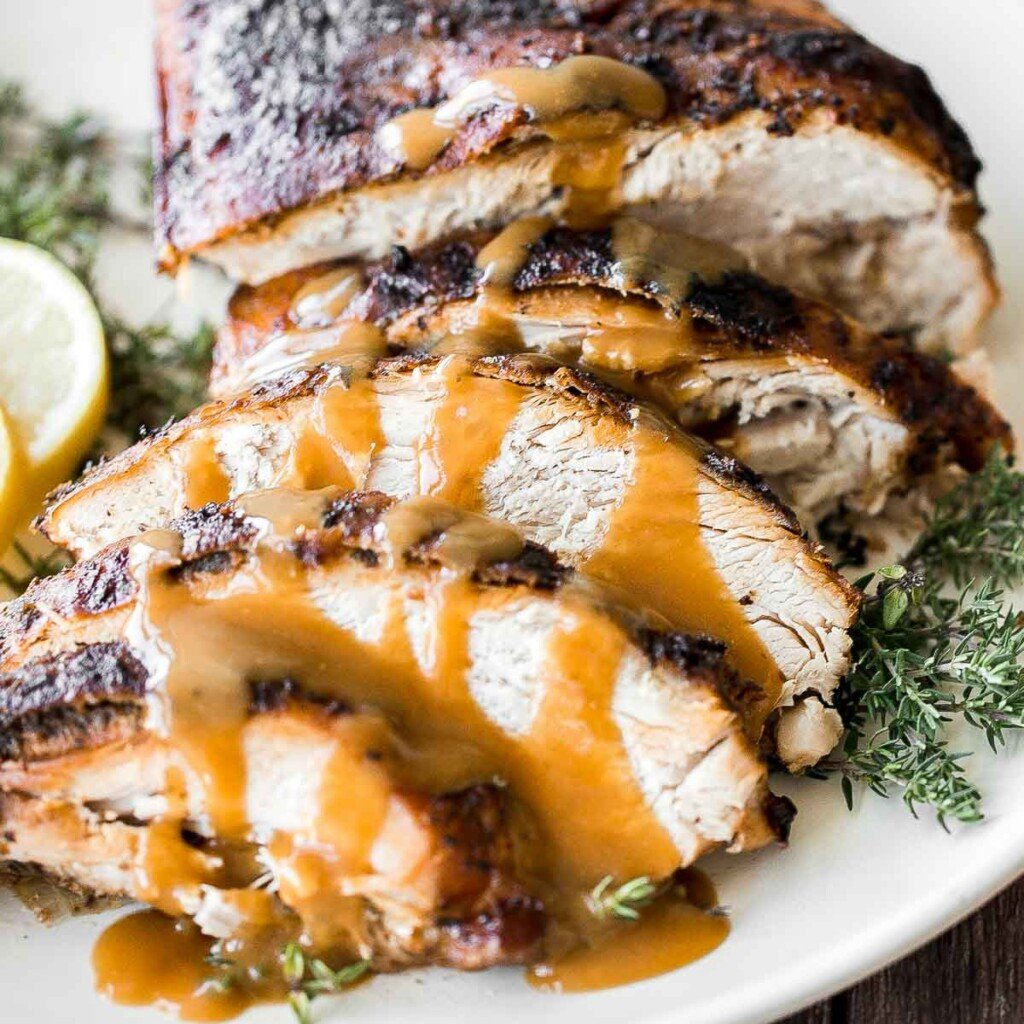 Juicy slow cooker turkey breast with crispy skin, garlic, and fresh herbs. An easy crockpot recipe for tender, flavorful turkey every time. | aheadofthyme.com