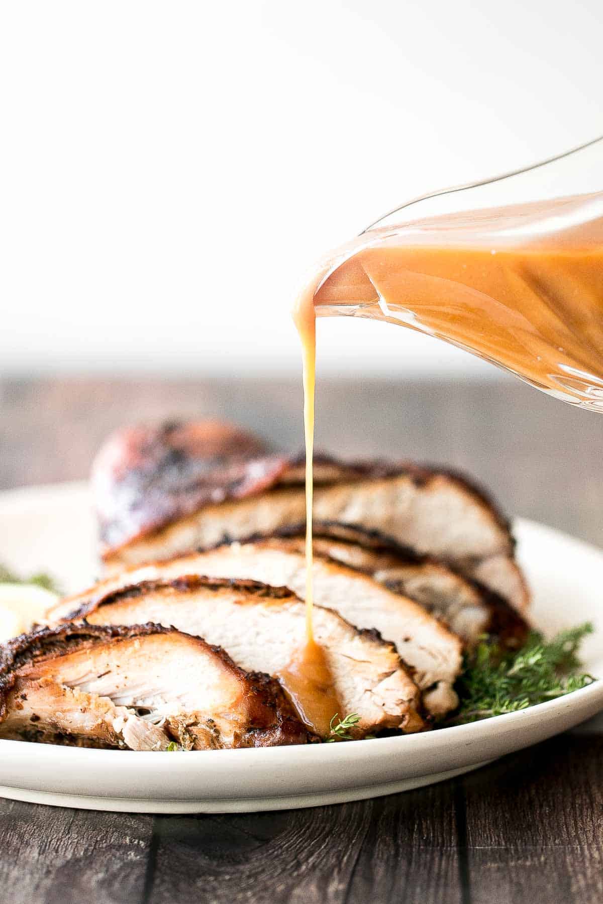 Juicy slow cooker turkey breast with crispy skin, garlic, and fresh herbs. An easy crockpot recipe for tender, flavorful turkey every time. | aheadofthyme.com