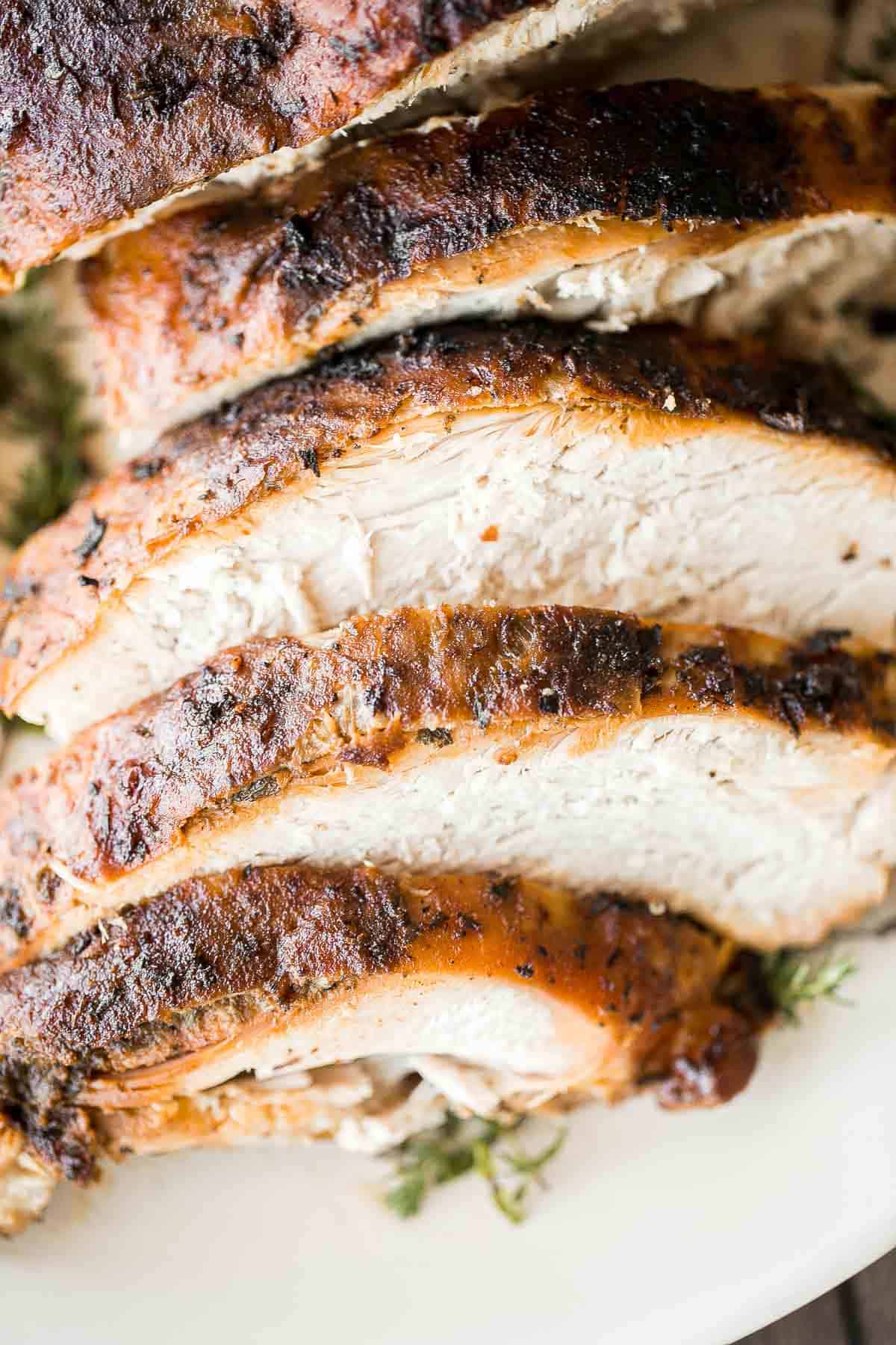 Juicy slow cooker turkey breast with crispy skin, garlic, and fresh herbs. An easy crockpot recipe for tender, flavorful turkey every time. | aheadofthyme.com