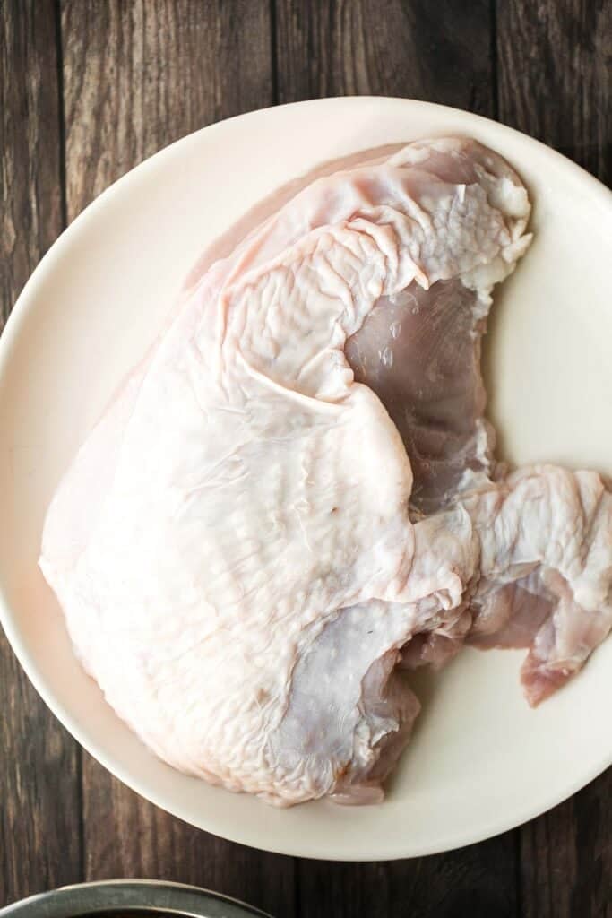 Juicy slow cooker turkey breast with crispy skin, garlic, and fresh herbs. An easy crockpot recipe for tender, flavorful turkey every time. | aheadofthyme.com