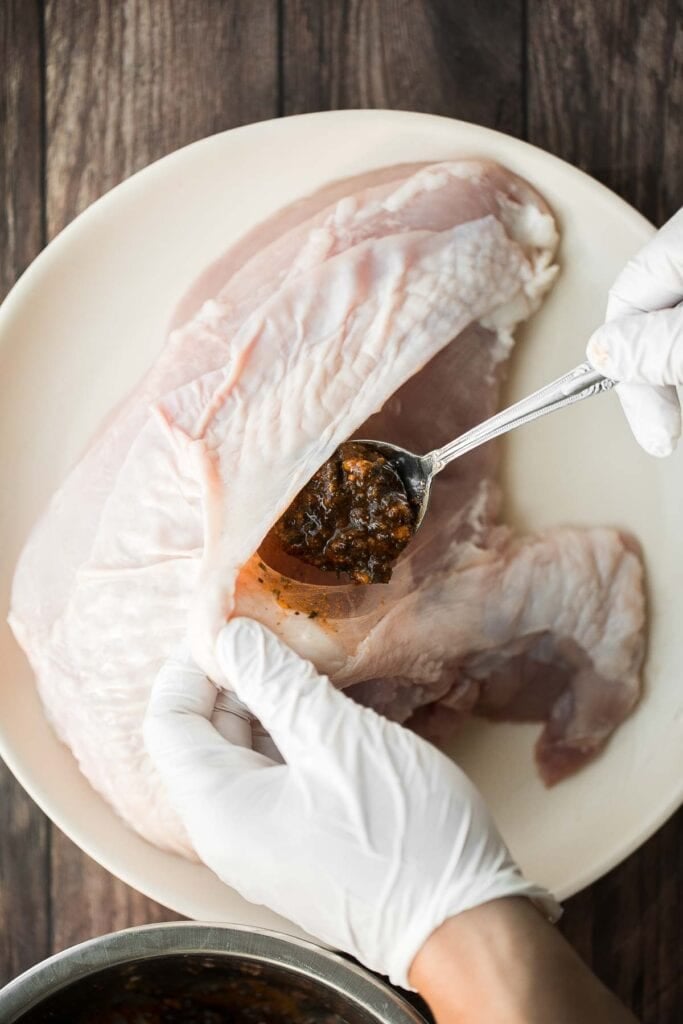 Juicy slow cooker turkey breast with crispy skin, garlic, and fresh herbs. An easy crockpot recipe for tender, flavorful turkey every time. | aheadofthyme.com