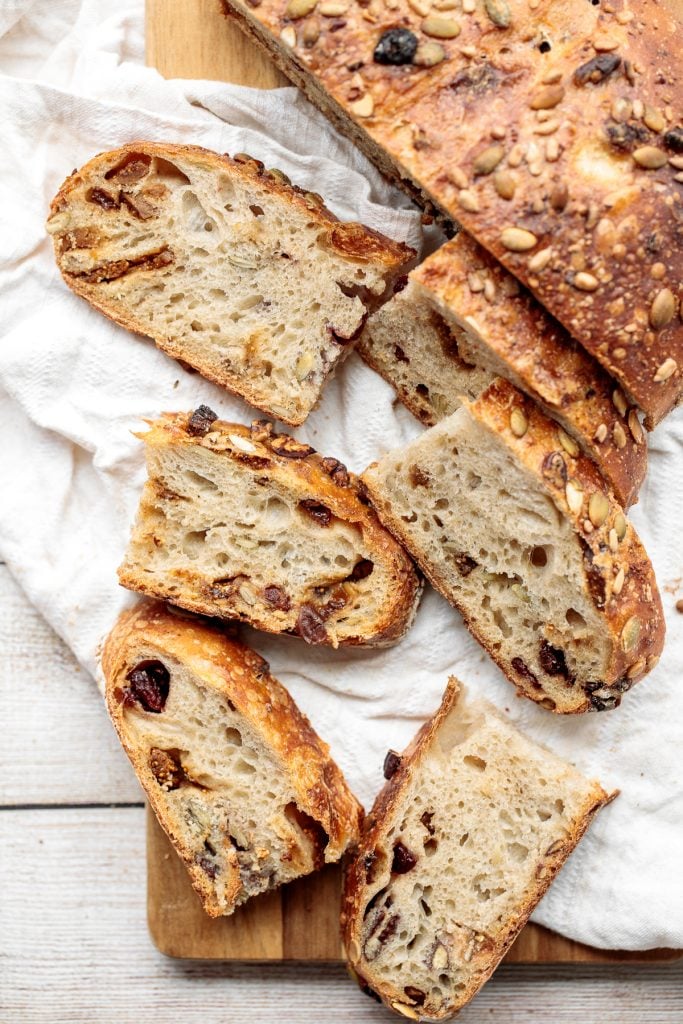 Fruit and nut sourdough bread is chewy and airy with a crunchy crackly crust is so delicious, packed with dried figs, raisins, walnuts, and seeds. | aheadofthyme.com