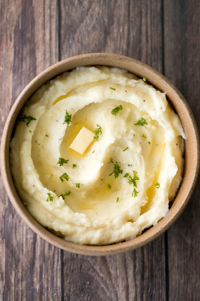 Velvety and smooth, garlic mashed potatoes with sour cream are the best, flavourful make-ahead side dish ever. Garlicky, buttery, creamy, and pure comfort. | aheadofthyme.com