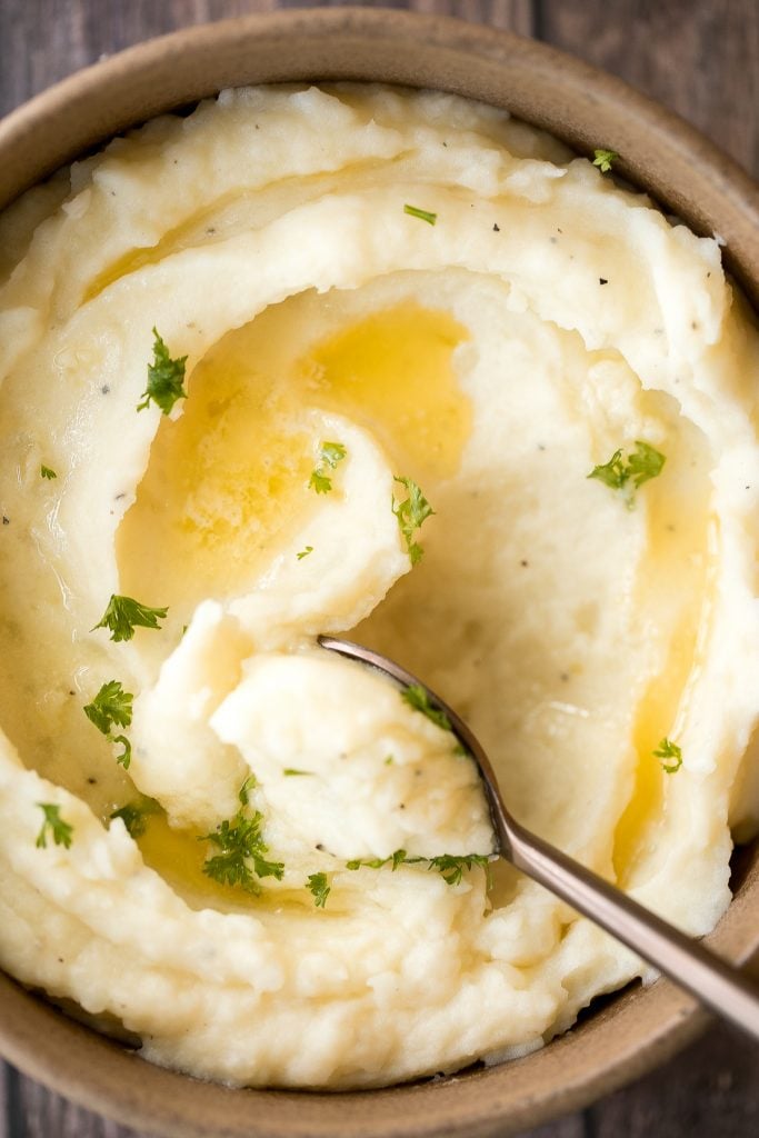 Velvety and smooth, garlic mashed potatoes with sour cream are the best, flavourful make-ahead side dish ever. Garlicky, buttery, creamy, and pure comfort. | aheadofthyme.com