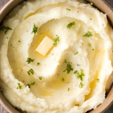 Velvety and smooth, garlic mashed potatoes with sour cream are the best, flavourful make-ahead side dish ever. Garlicky, buttery, creamy, and pure comfort. | aheadofthyme.com