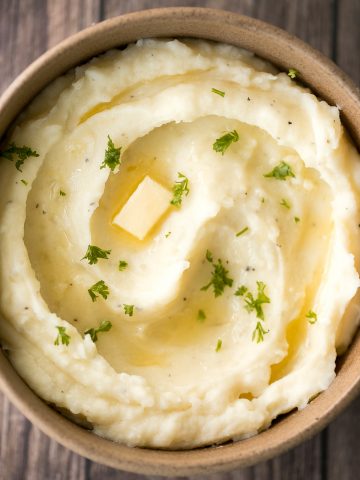 Velvety and smooth, garlic mashed potatoes with sour cream are the best, flavourful make-ahead side dish ever. Garlicky, buttery, creamy, and pure comfort. | aheadofthyme.com