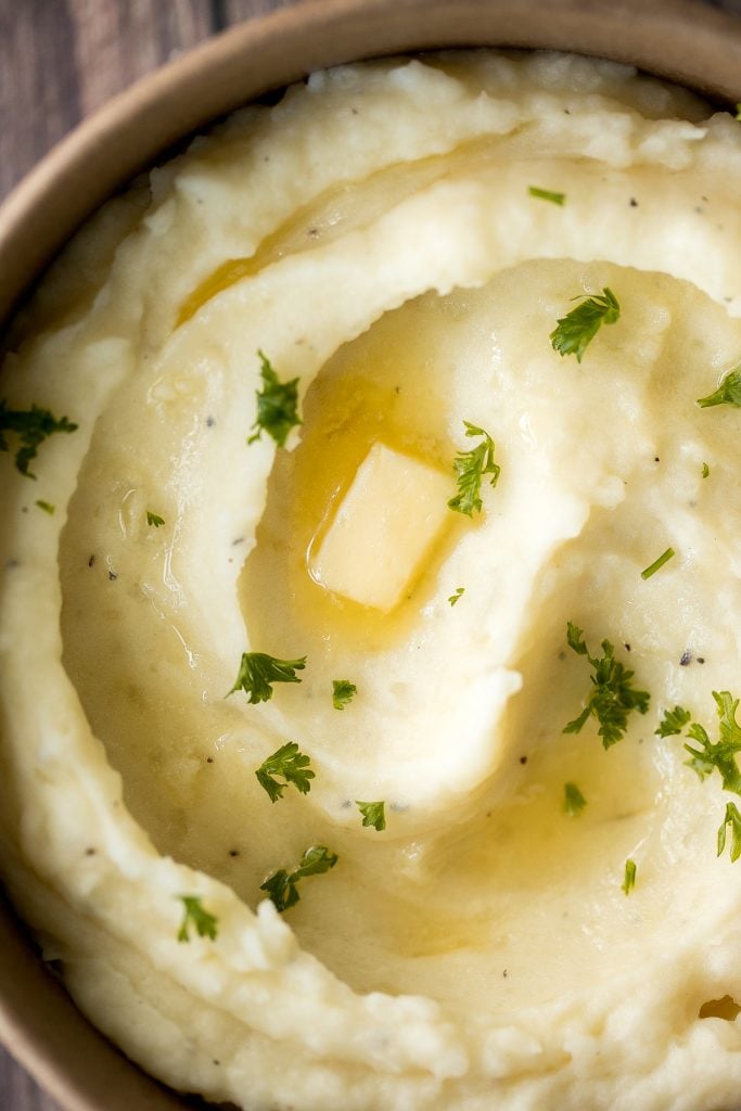 Velvety and smooth, garlic mashed potatoes with sour cream are the best, flavourful make-ahead side dish ever. Garlicky, buttery, creamy, and pure comfort. | aheadofthyme.com