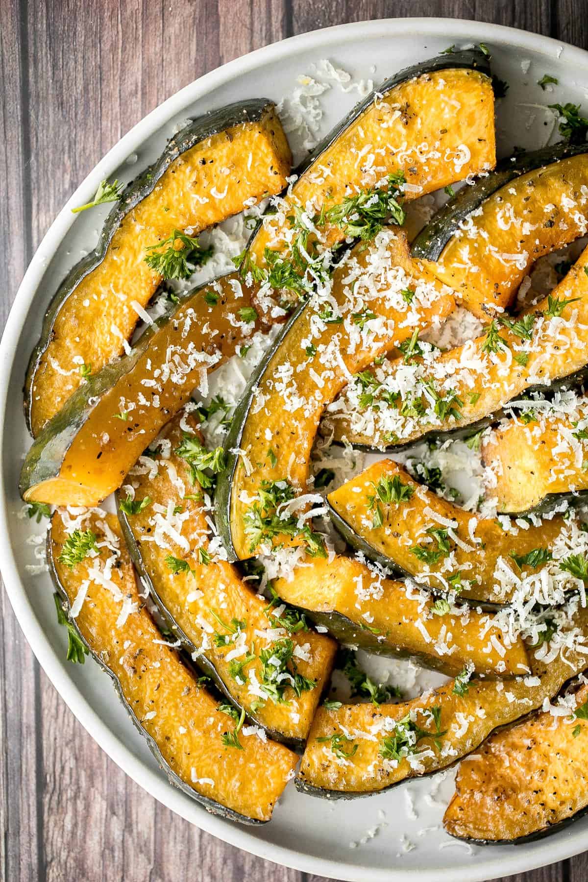 Soft and tender, easy roasted pumpkin wedges with Parmesan cheese is the easiest and most delicious side dishes to make this fall. Prep it in just minutes. | aheadofthyme.com