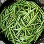 Buttery sautéed garlic green beans is a simple side dish that is quick, easy and delicious. Make these vibrant, crispy and tender green beans in 10 minutes. | aheadofthyme.com