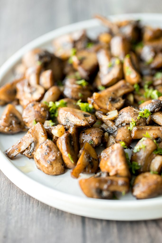 Buttery sautéed garlic mushrooms are silky smooth with an incredible caramelization and earthy rich flavour. A simple side dish in under 15 minutes. | aheadofthyme.com