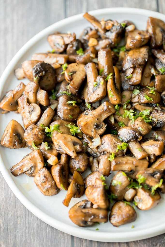 Buttery sautéed garlic mushrooms are silky smooth with an incredible caramelization and earthy rich flavour. A simple side dish in under 15 minutes. | aheadofthyme.com