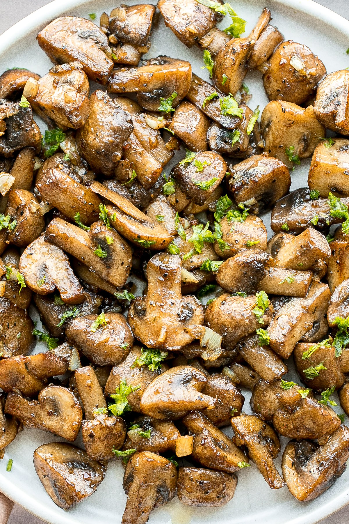 Buttery sautéed garlic mushrooms are silky smooth with an incredible caramelization and earthy rich flavour. A simple side dish in under 15 minutes. | aheadofthyme.com