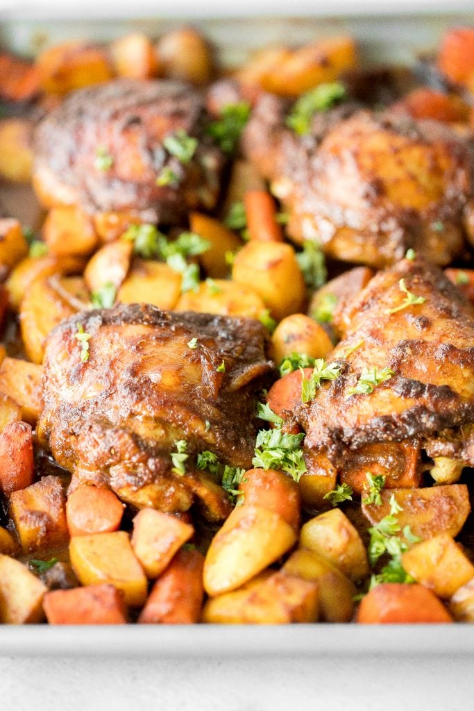 Sheet pan curry chicken and vegetables with tender chicken thighs marinated in a delicious flavourful curry marinade is a complete one pan dinner. | aheadofthyme.com