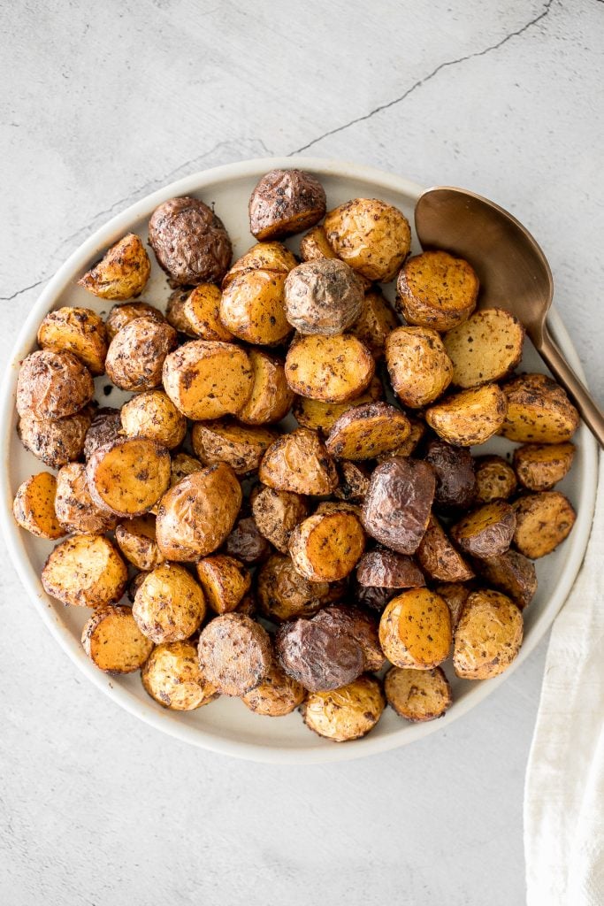 Crispy and tender, easy air fryer baby potatoes are a healthier take on a classic side dish without compromising taste or texture. Cooks in just 20 minutes. | aheadofthyme.com