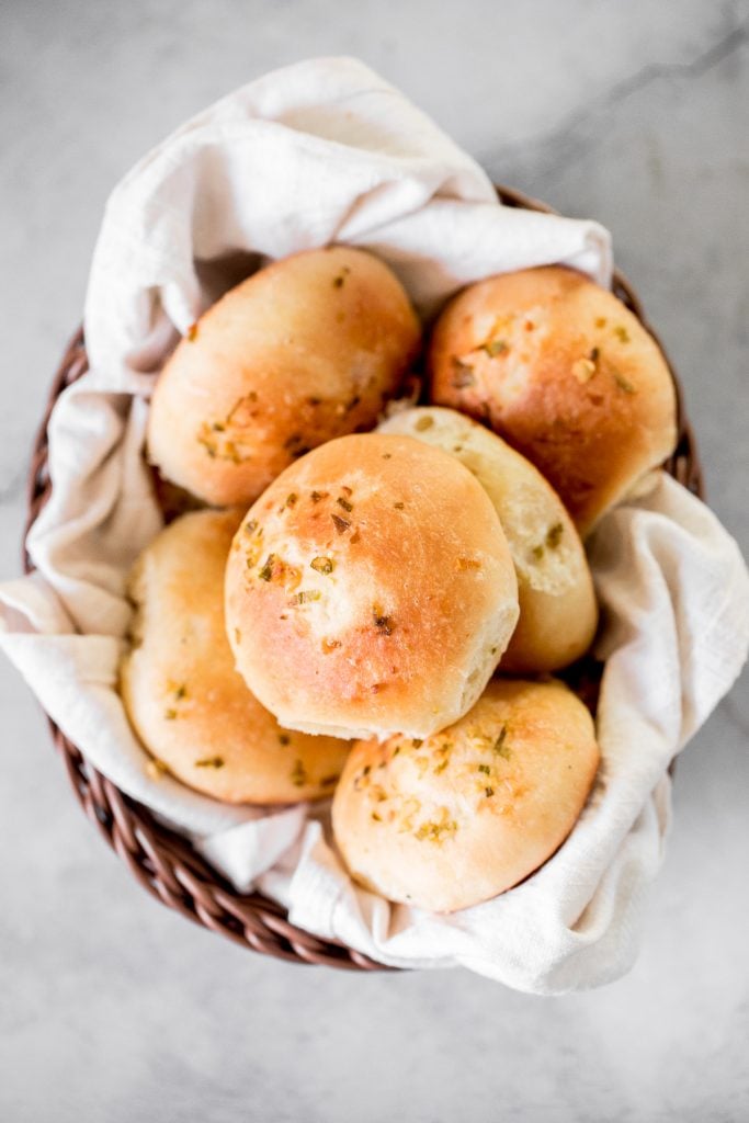 Quick and easy, 90-minute cheesy garlic dinner rolls are soft and fluffy, buttery and garlicky, and full of cheese inside. The perfect side for dinner. | aheadofthyme.com