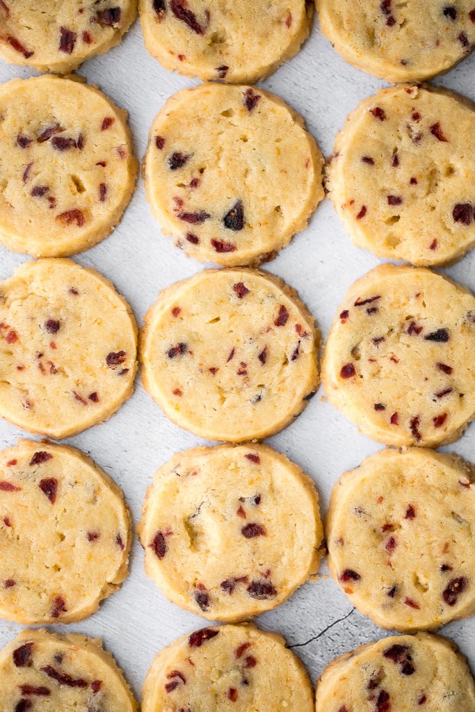 Cranberry orange shortbread cookies are bursting with flavour from dried cranberries and fresh orange zest. These easy cookies are rolled, sliced and baked. | aheadofthyme.com