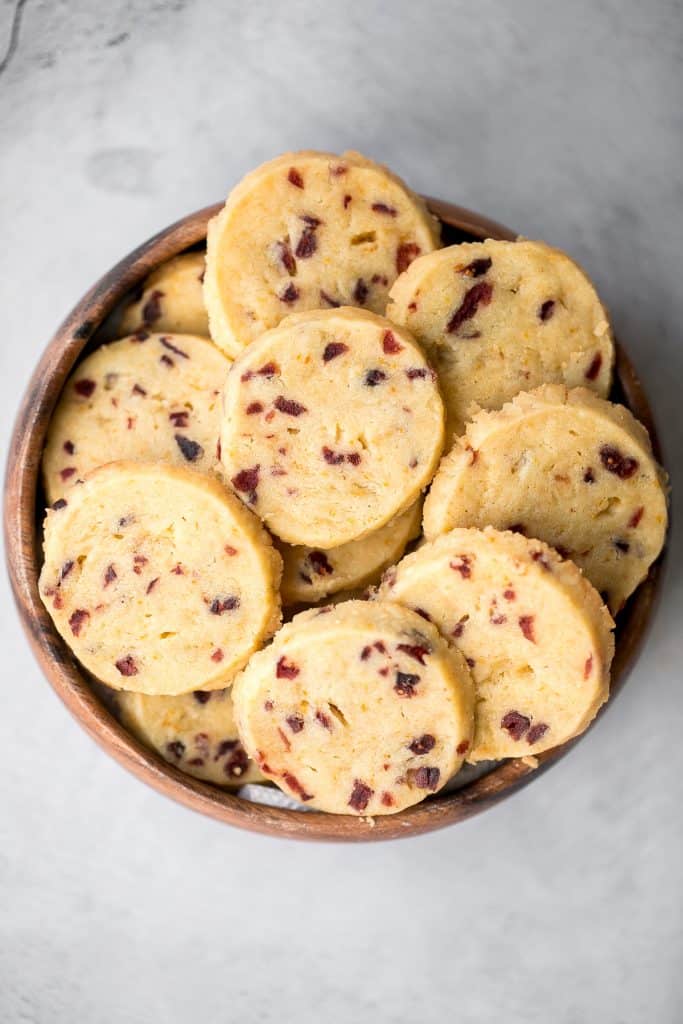 Cranberry orange shortbread cookies are bursting with flavour from dried cranberries and fresh orange zest. These easy cookies are rolled, sliced and baked. | aheadofthyme.com