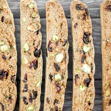 Festive cranberry pistachio biscotti are crunchy, delicious, and perfect for dunking. This Italian cookie is easy to make with warm holiday flavours. | aheadofthyme.com